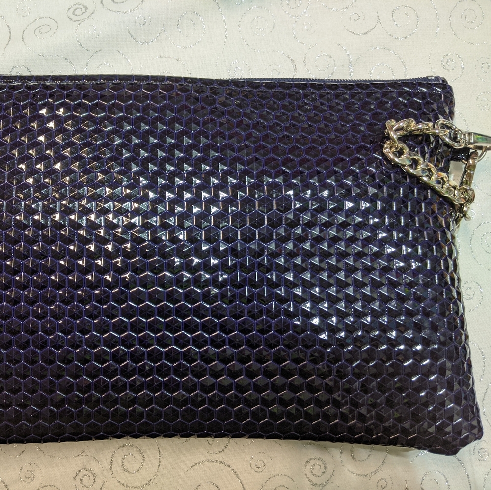 Wristlet purse with zipper top. Iridescent, black, purple and blue.